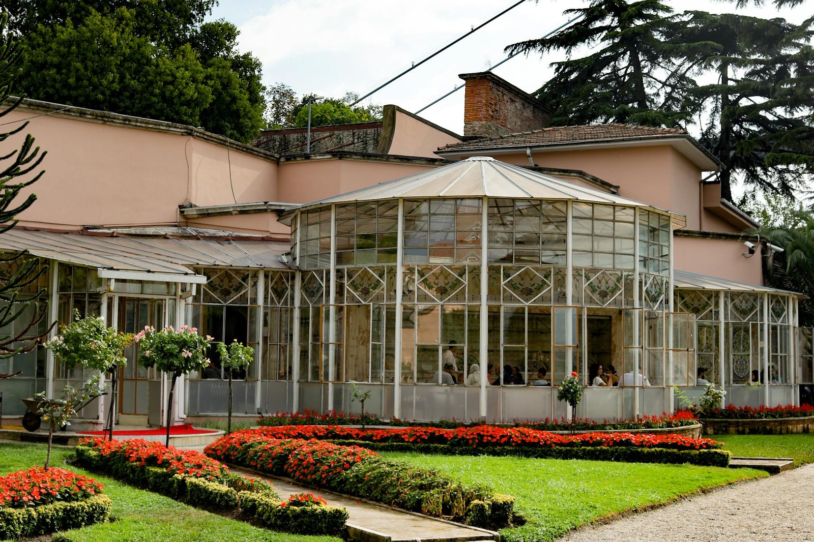 A beautiful glasshouse restaurant surrounded by vibrant gardens in Istanbul, Turkey.